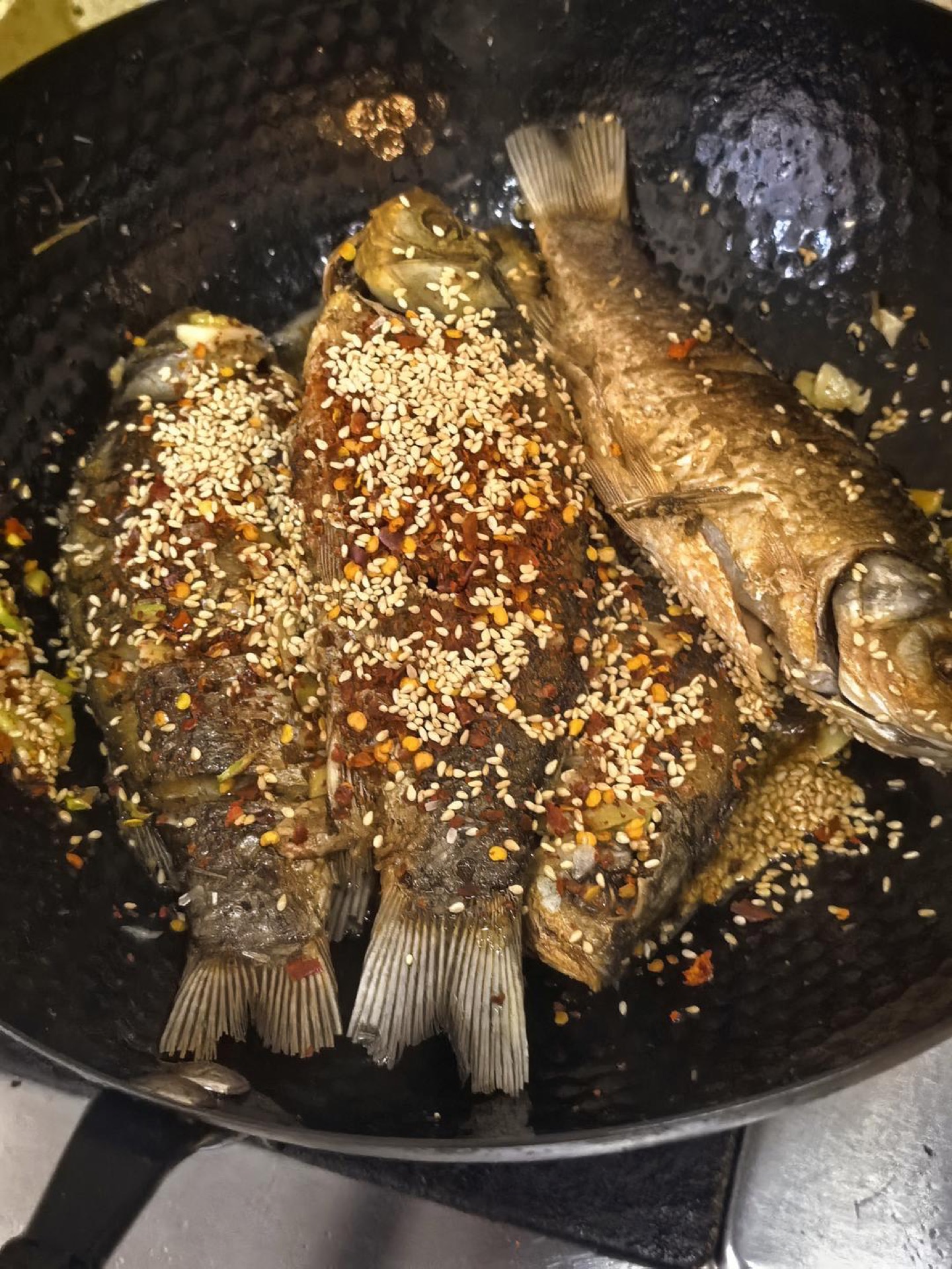 Soy sauce being drizzled around the edge of the wok