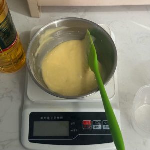 Egg yolk being stirred into the batter