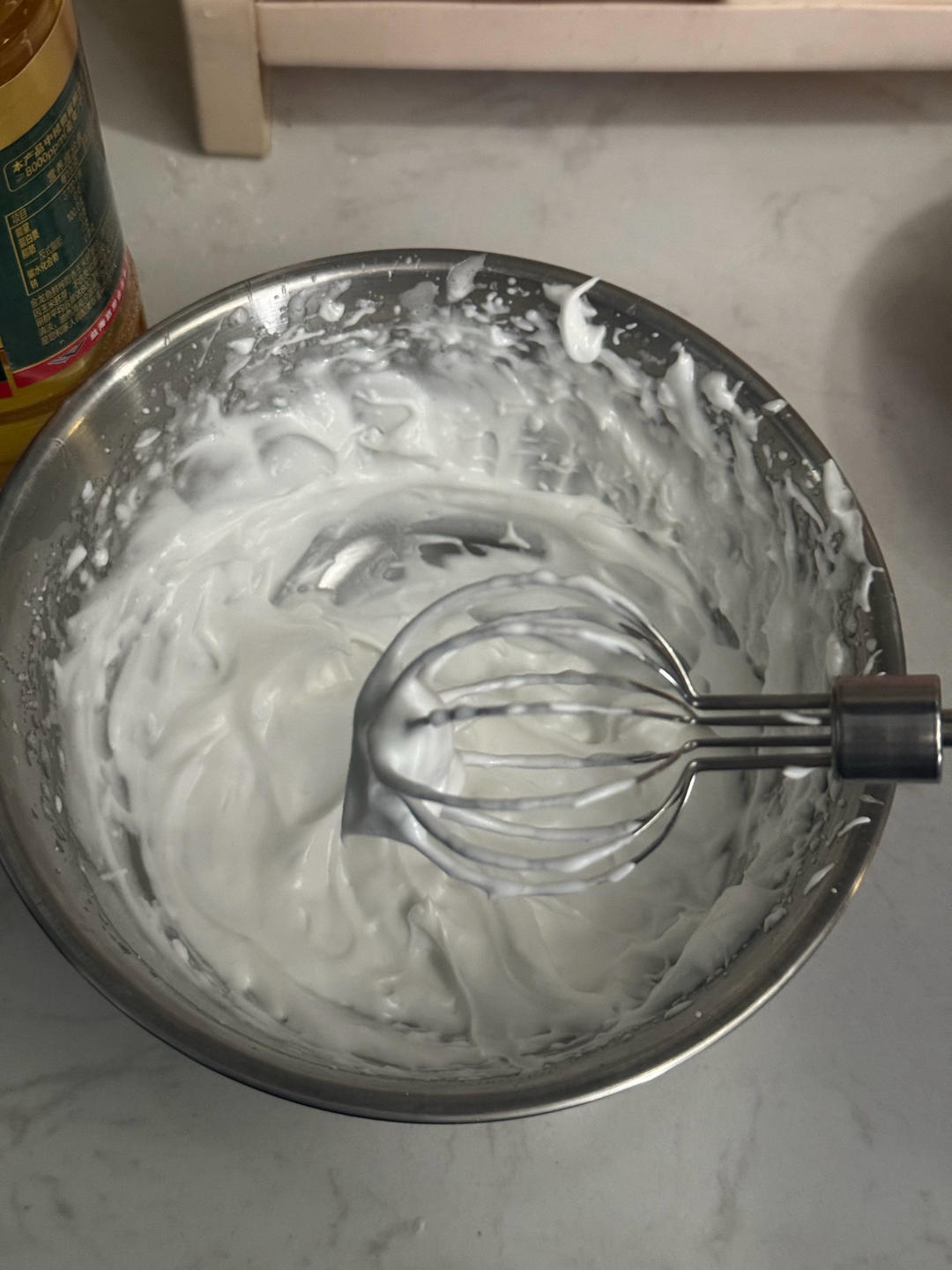 Egg white being whipped to stiff glossy peaks