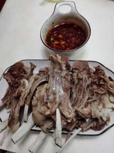 Cut lamb chops on a platter with the chili dipping sauce ready to eat