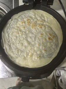 Ladle the batter into a hot oiled wok and spread it into slightly thick pancakes, cooking until just set.