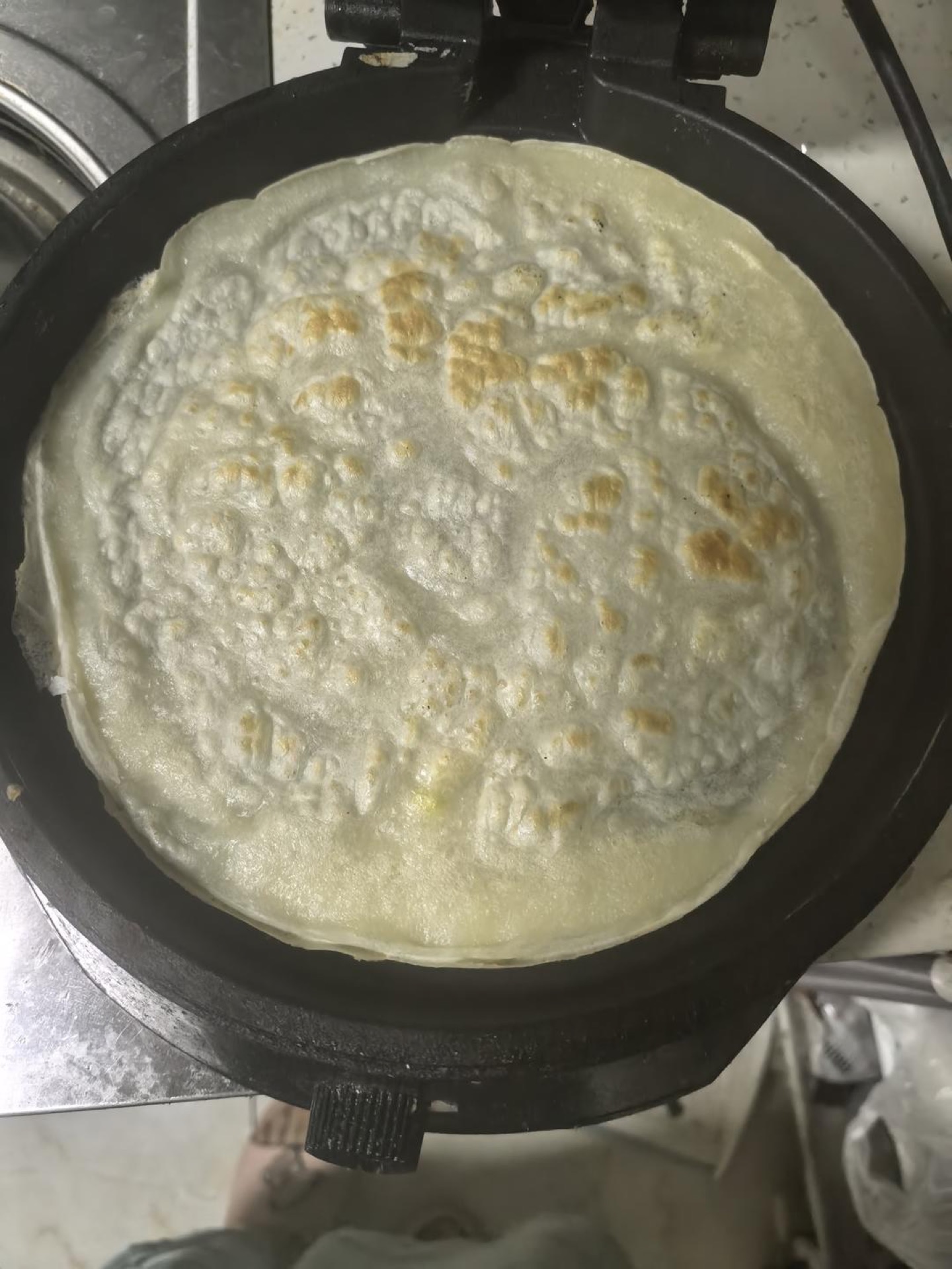 Ladle the batter into a hot oiled wok and spread it into slightly thick pancakes, cooking until just set.