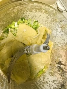 Let the pancakes cool, cut them into large pieces, then grind them together with the scallions, ginger, and pork belly to a coarse, granular texture.