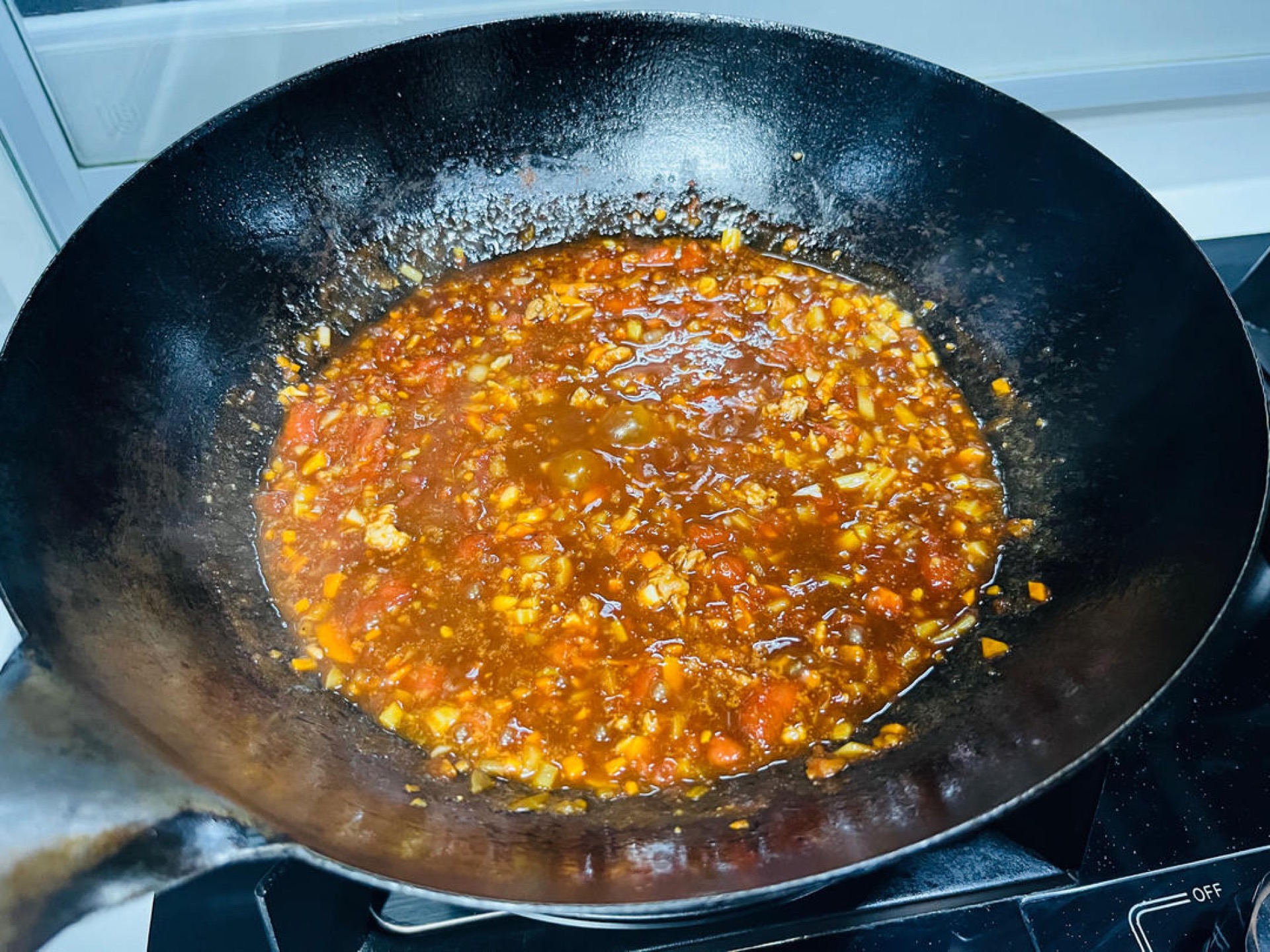 Simmer over low heat until the sauce is thick and clings to the side of the wok.