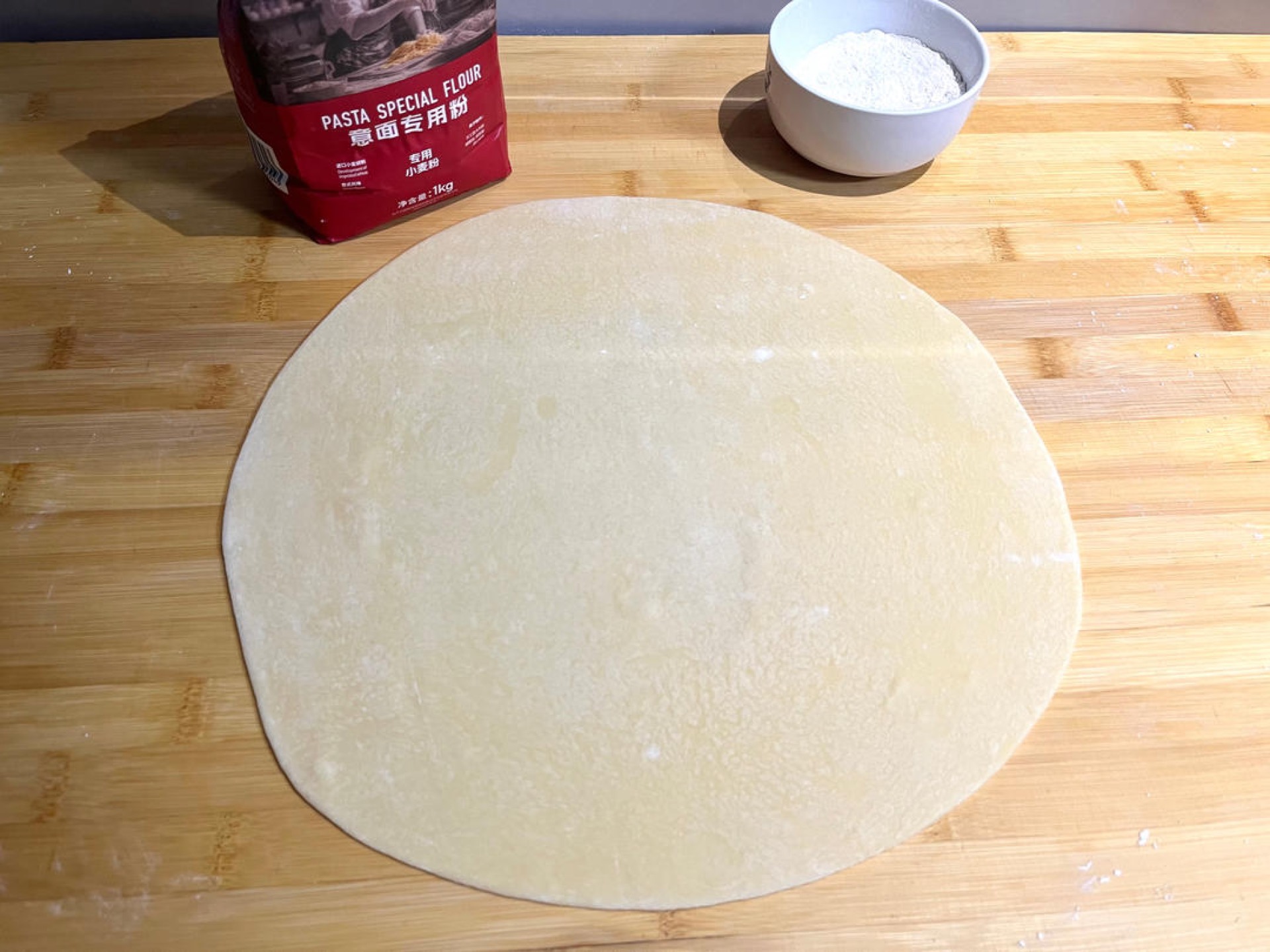 Dust the rested dough with a little pasta flour and roll it into a thin sheet.
