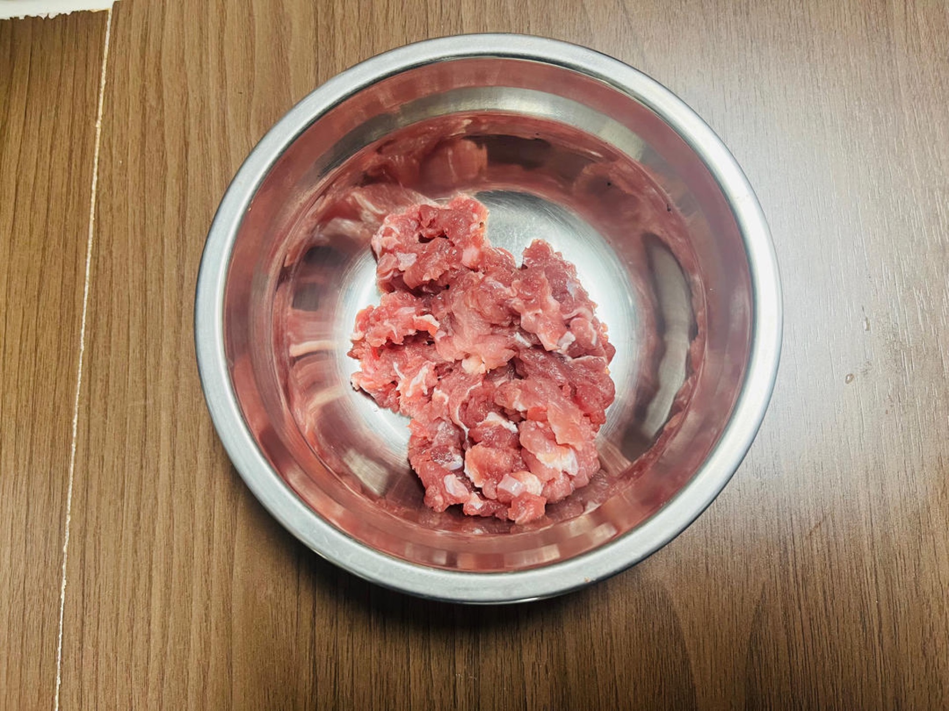 While the dough rests, make the sauce: mince the meat.