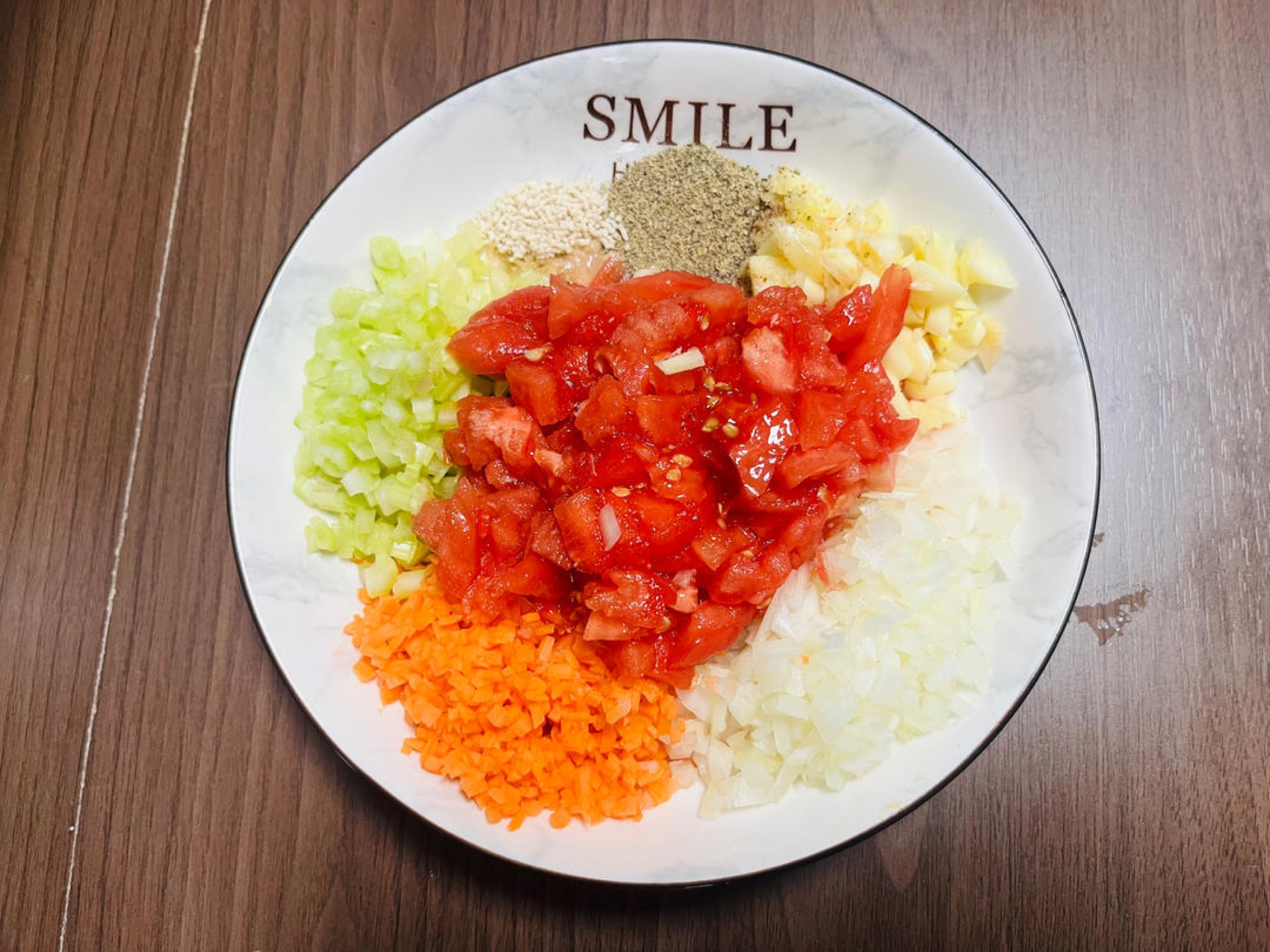 Finely chop the tomato, onion, carrot, celery, and garlic.