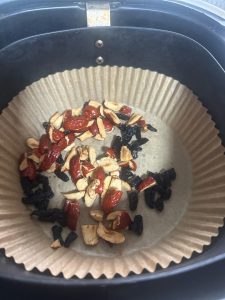 Chopped red dates and raisins on a wooden board