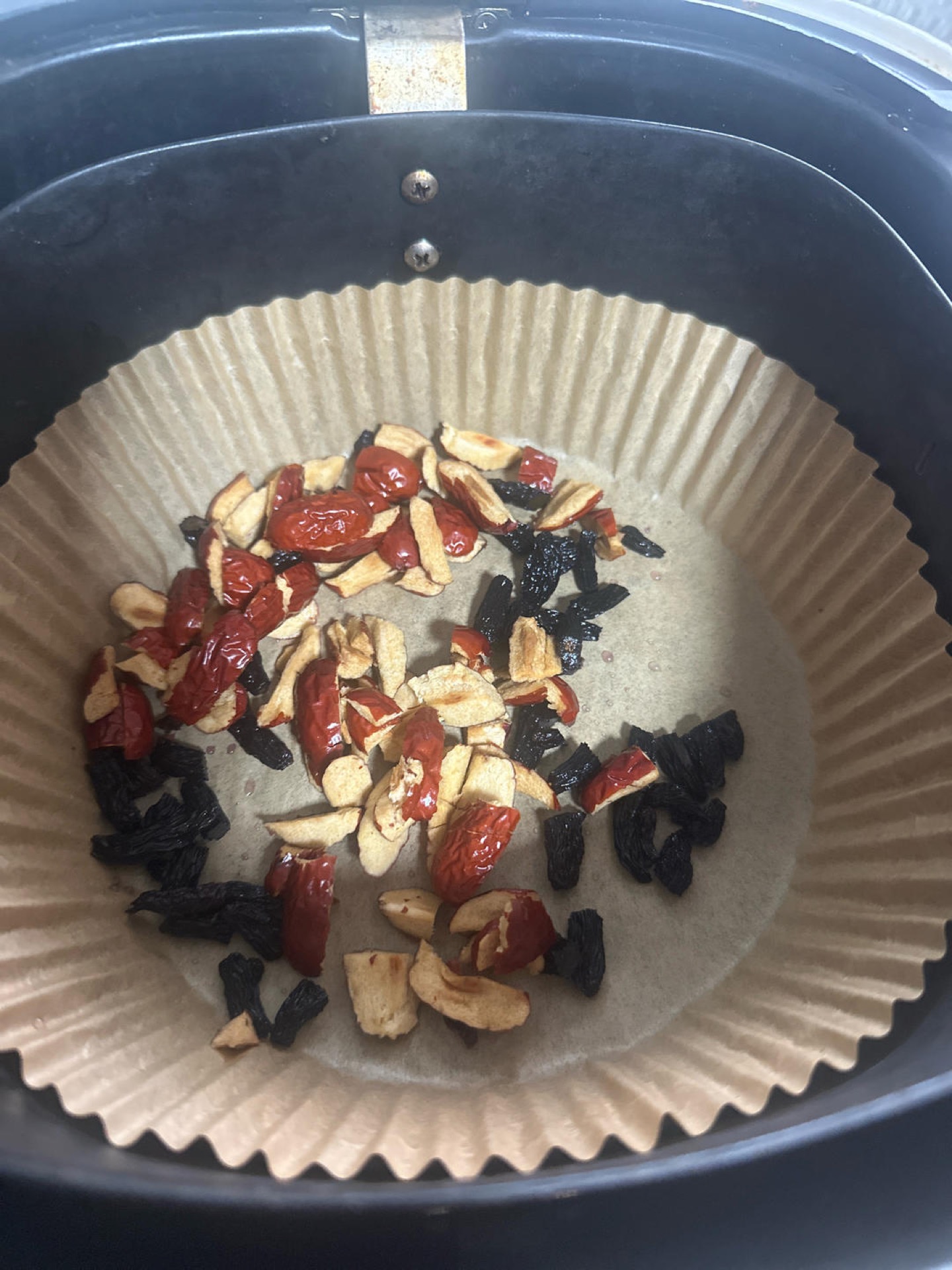 Chopped red dates and raisins on a wooden board
