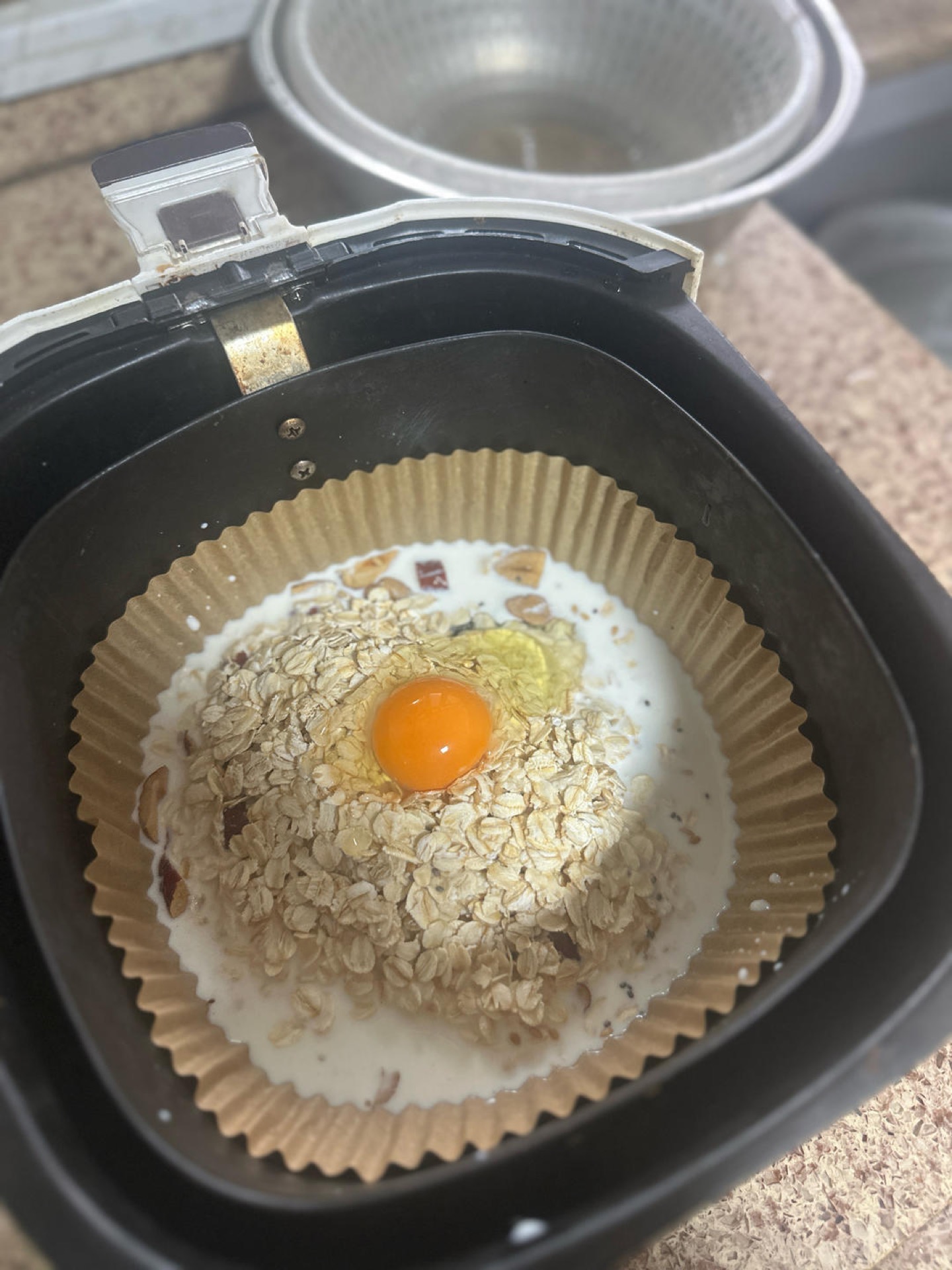 Oat, milk, egg, and date mixture stirred together in a bowl