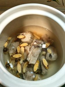 Simmering the ribs and herbs in boiling water