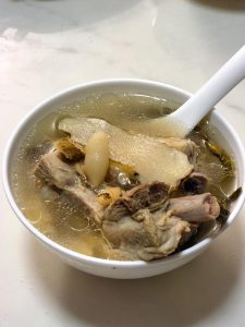 Bowl of clear herbal pork rib soup ready to serve