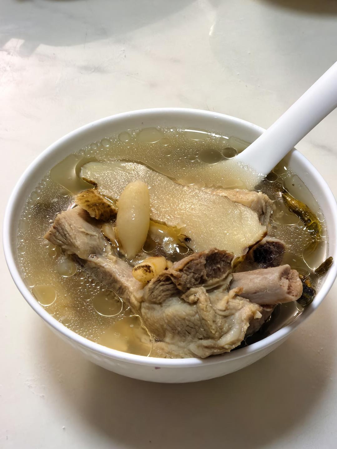 Bowl of clear herbal pork rib soup ready to serve