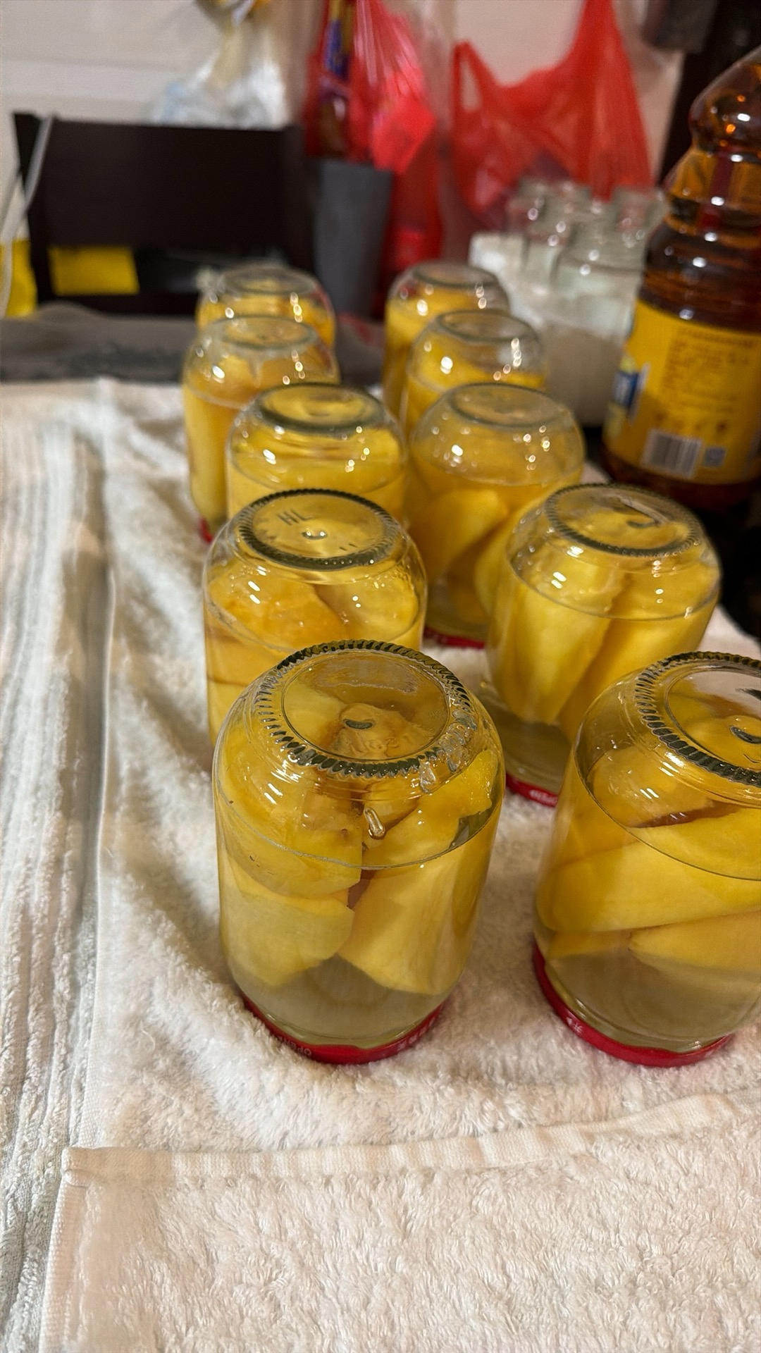 Jars of homemade canned yellow peaches in syrup