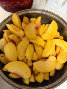 Peach wedges soaking in lightly salted water