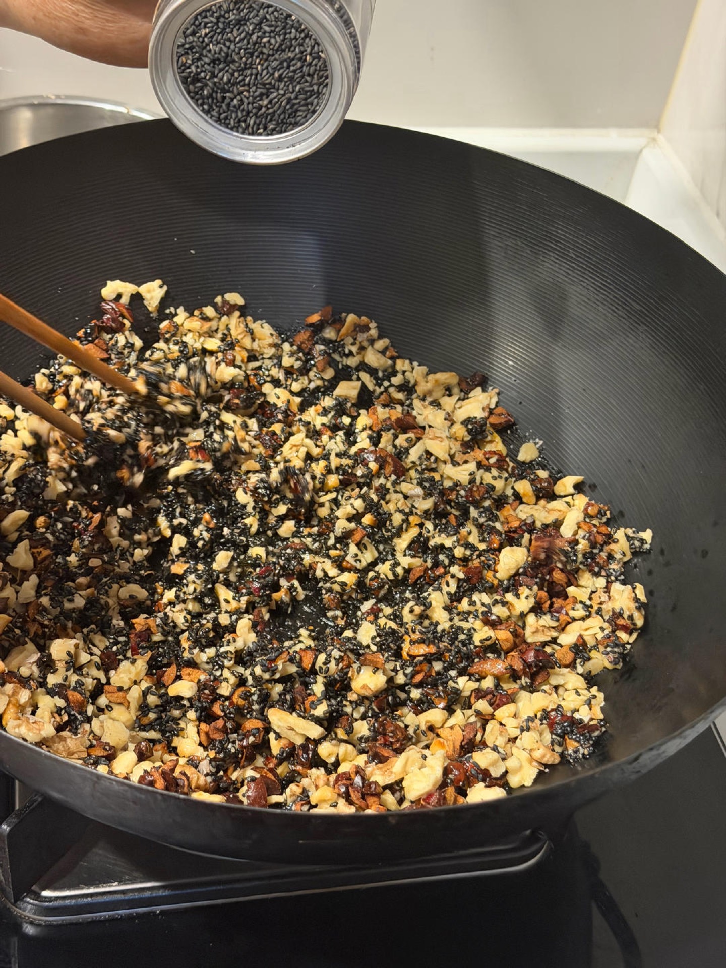 Dates, walnuts and sesame seeds combined in a bowl