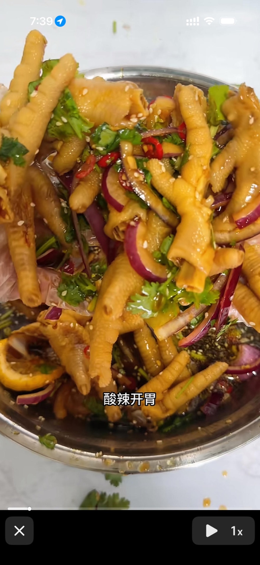 Hot and sour chicken feet (酸辣鸡爪) in a bowl, tossed with chile, garlic, lime and sesame seeds
