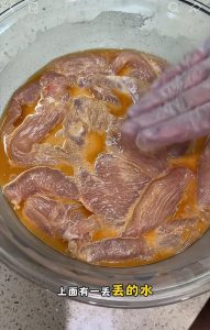 Re-mixing the settled marinade with the chicken after an overnight rest in the fridge