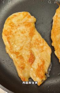 Golden pan-seared chicken cutlets sizzling in a hot skillet