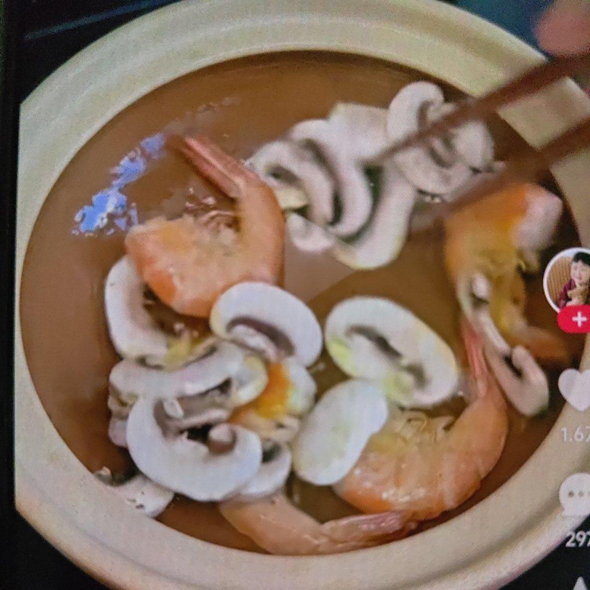 Add the button mushrooms to the pot and stir-fry with the shrimp until they soften and release their aroma.