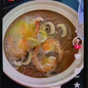 Pour in the water and bring it up to a gentle simmer to build the broth.