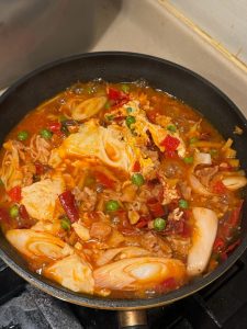 Aromatics for Korean spicy rabbit tofu soup prepped on a board