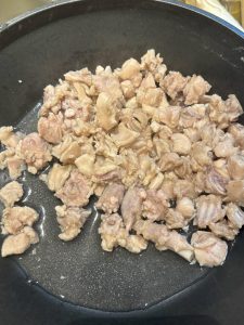 Blanched rabbit pieces draining in a strainer
