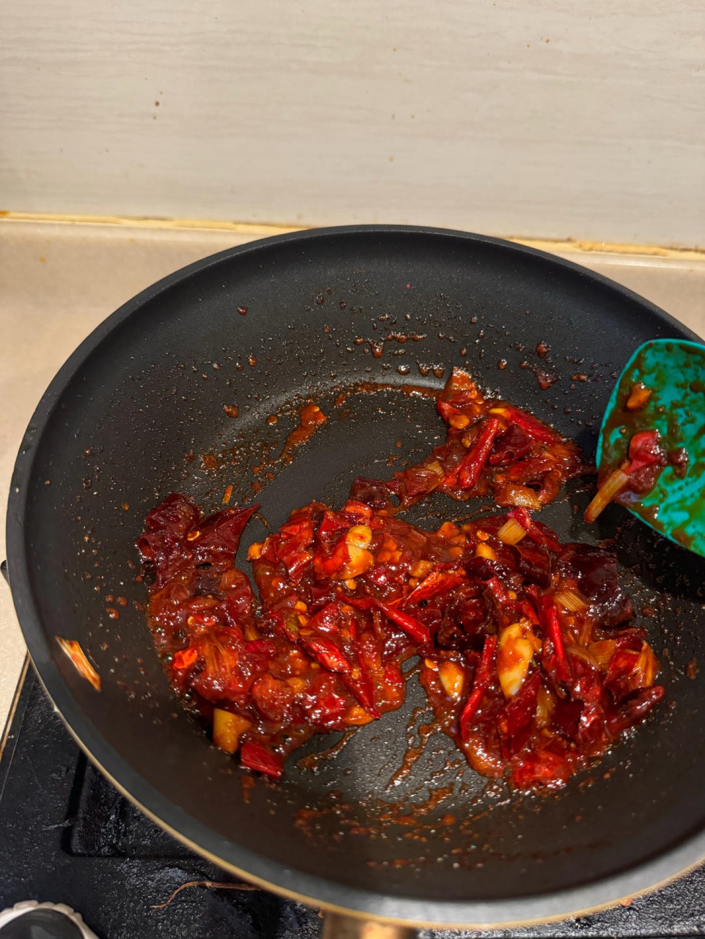 Chili flakes blooming in oil with gochujang