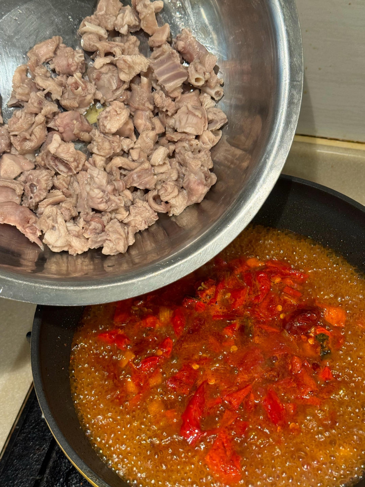 Rabbit simmering in a red chili broth