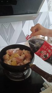 Pouring cola over the chicken wings