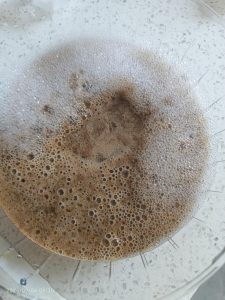Bowl of soapy water next to the stove