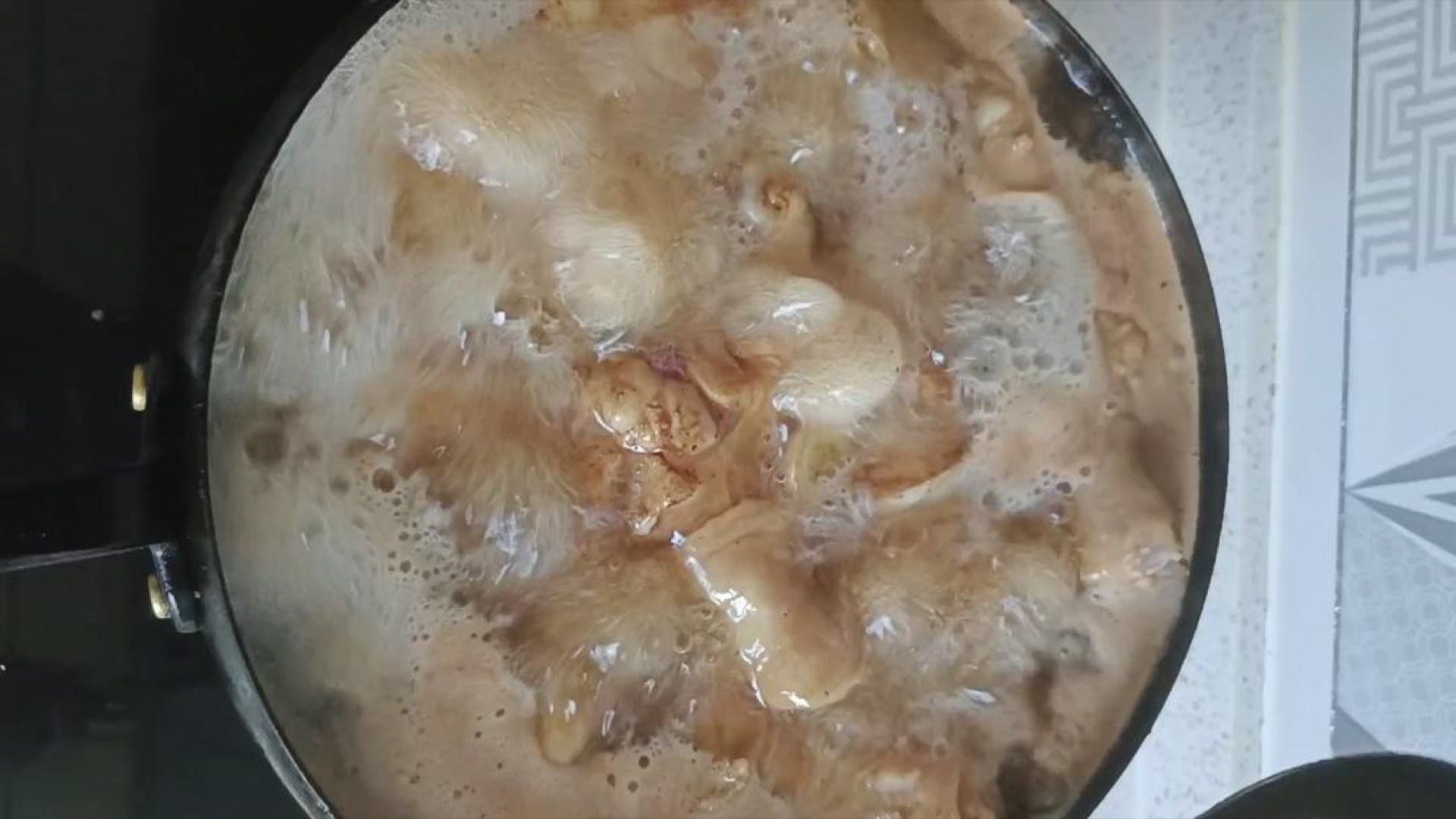 Sauce simmering gently after skimming