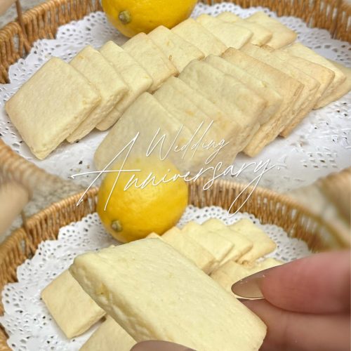 Crisp lemon cookies piled on a plate