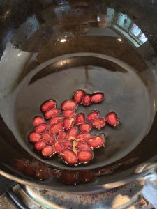 Hot oil shimmering in a wok ready for pouring