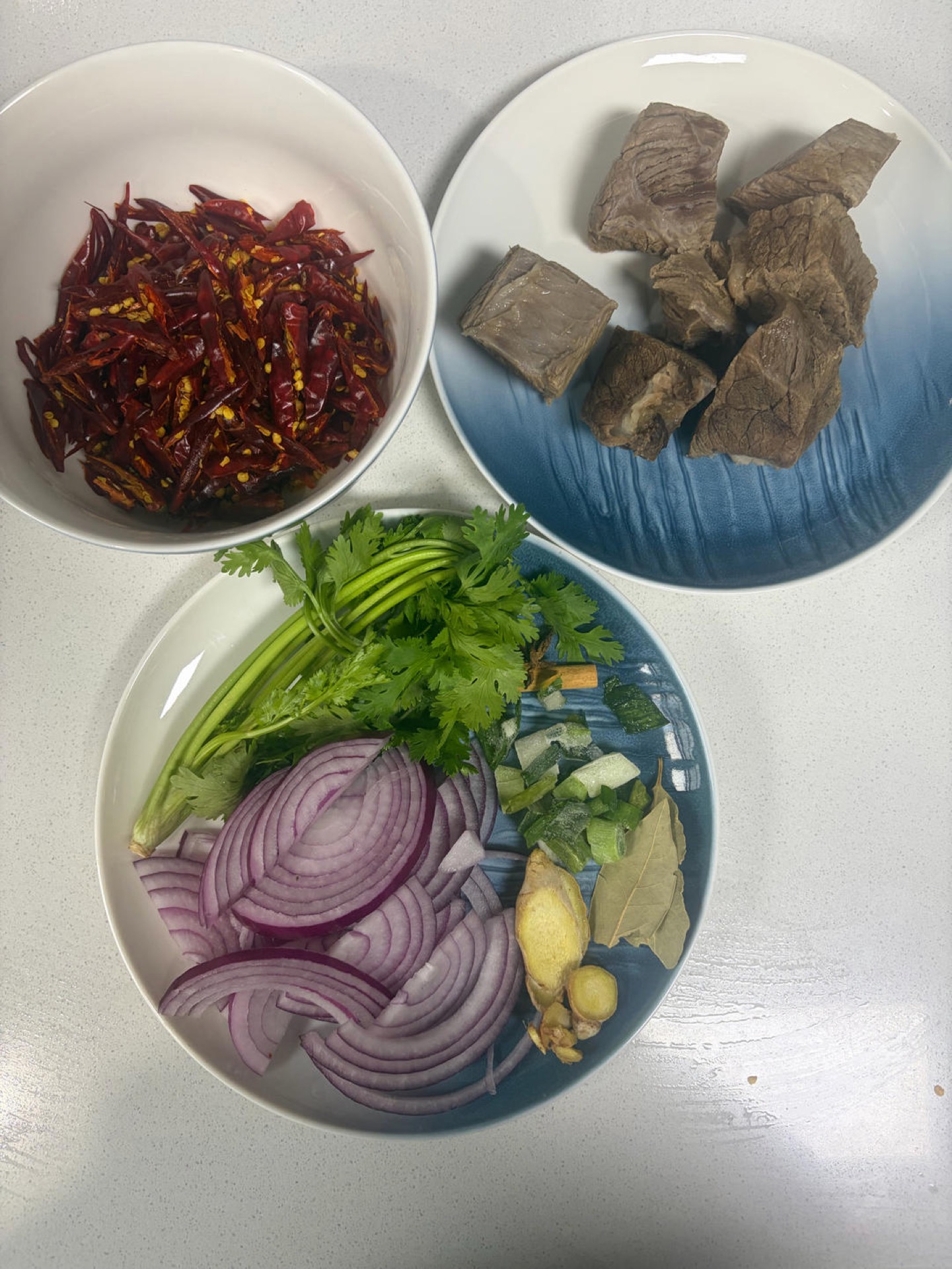 Cut the beef into roughly 5cm chunks, blanch in water with scallion, ginger and Shaoxing wine, skim off the blood foam when the water boils, then add 2 star anise, 30 Sichuan peppe
