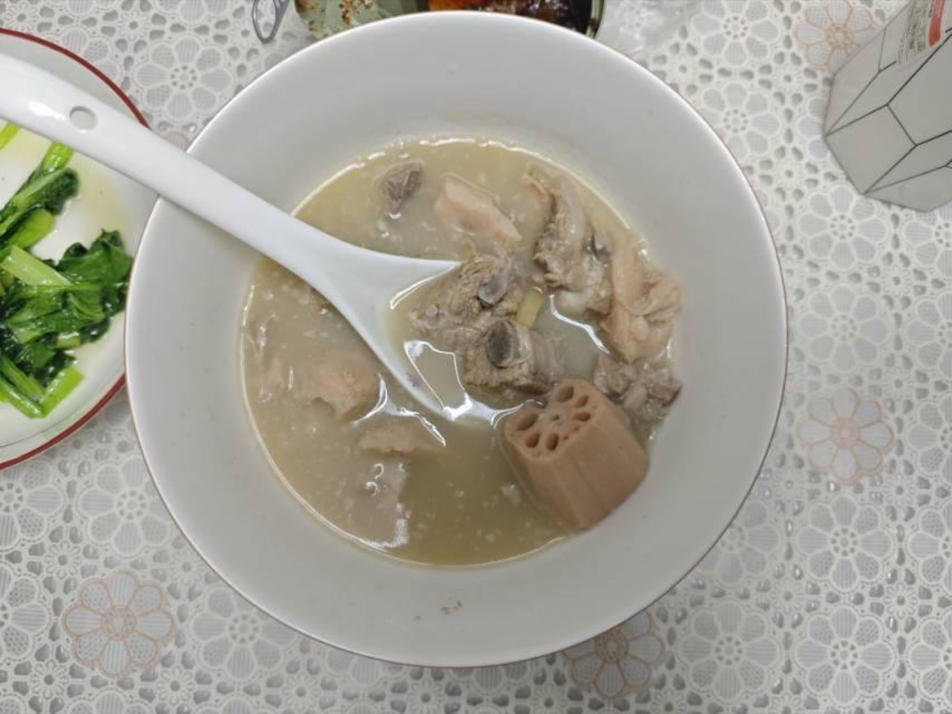 Lotus Root Pork Rib Soup (排骨藕汤) served in a white bowl with visible pork ribs and lotus root coins