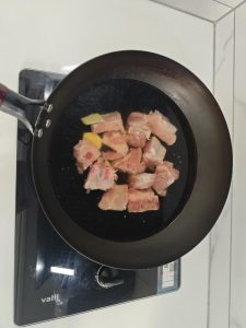 Pork ribs blanching in a pot with ginger and wine