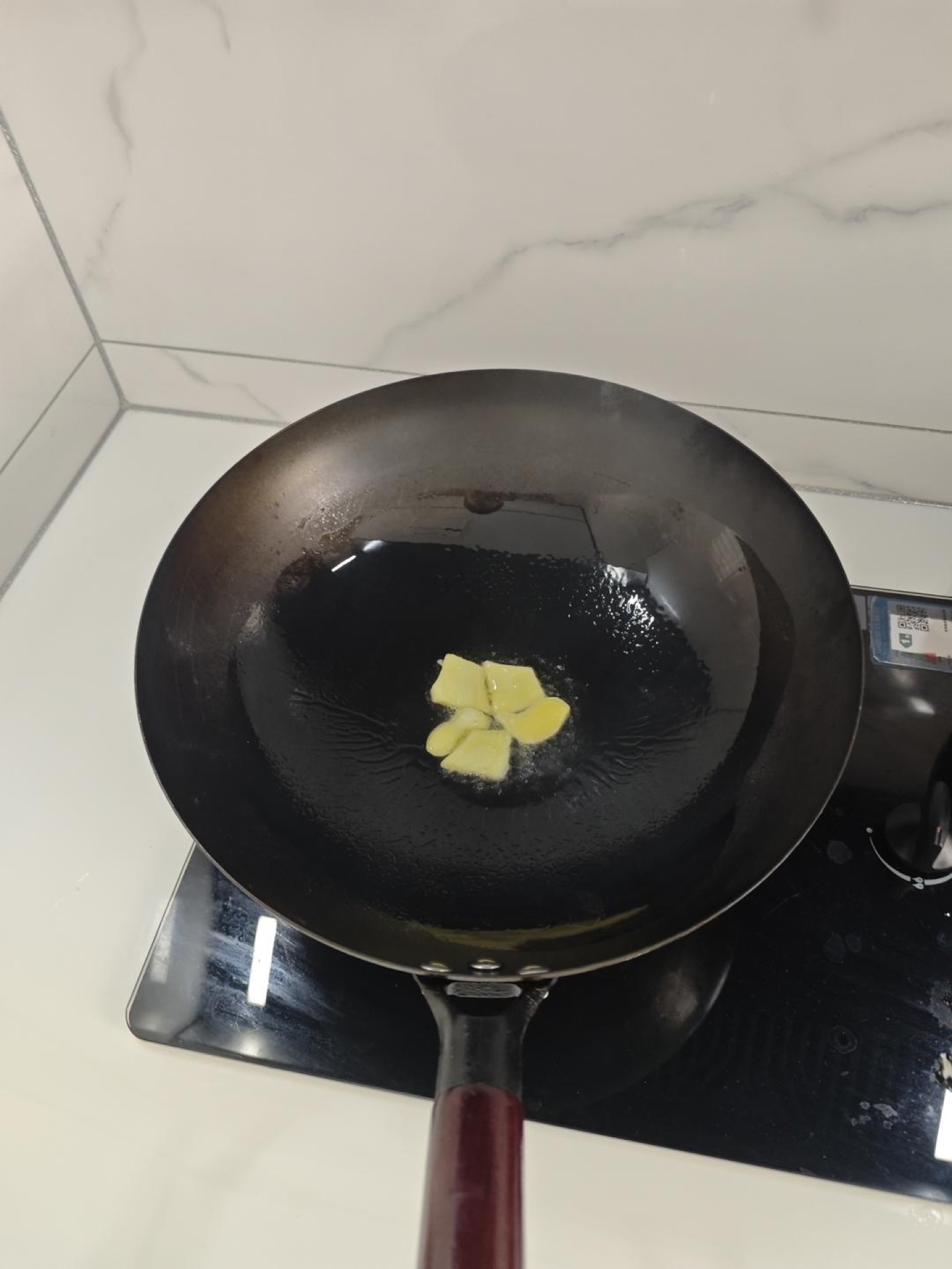 Ginger slices sizzling in oil in a heavy pot