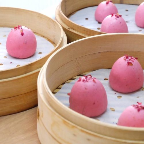 Low-Sugar Rose Yam Steamed Buns (家庭版低糖玫瑰山药馒头) stacked in a bamboo steamer