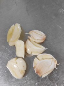 Press the garlic cloves with the flat side of a knife so the skins slip off easily, and cut the small red chili with kitchen shears if you want to keep your hands free of chili oil