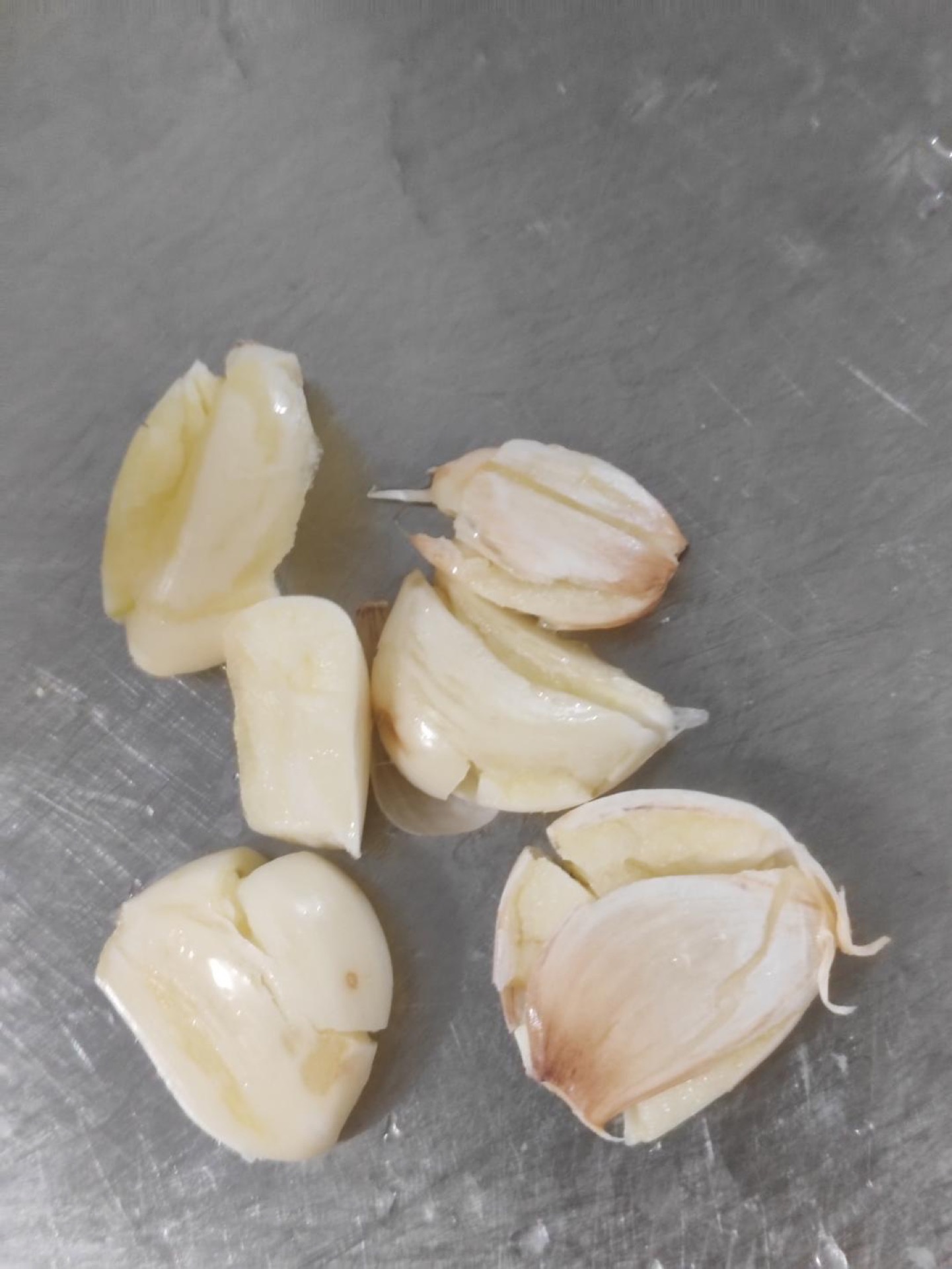 Press the garlic cloves with the flat side of a knife so the skins slip off easily, and cut the small red chili with kitchen shears if you want to keep your hands free of chili oil