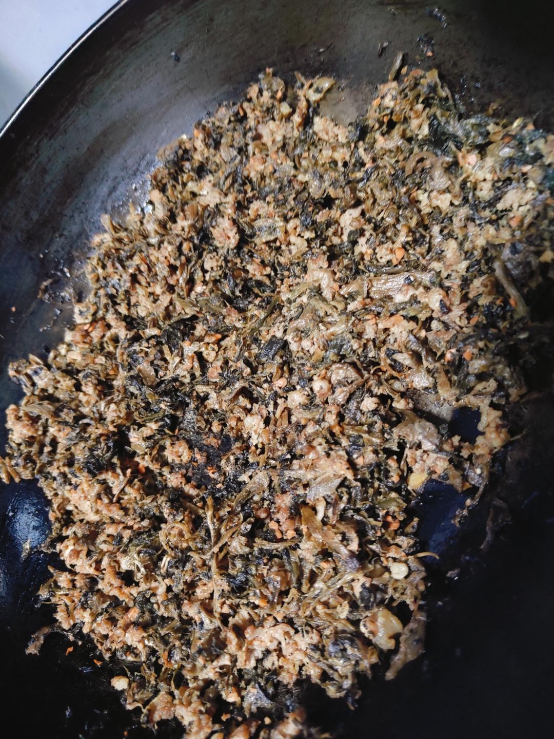 Pork mince being fried with ginger and spices