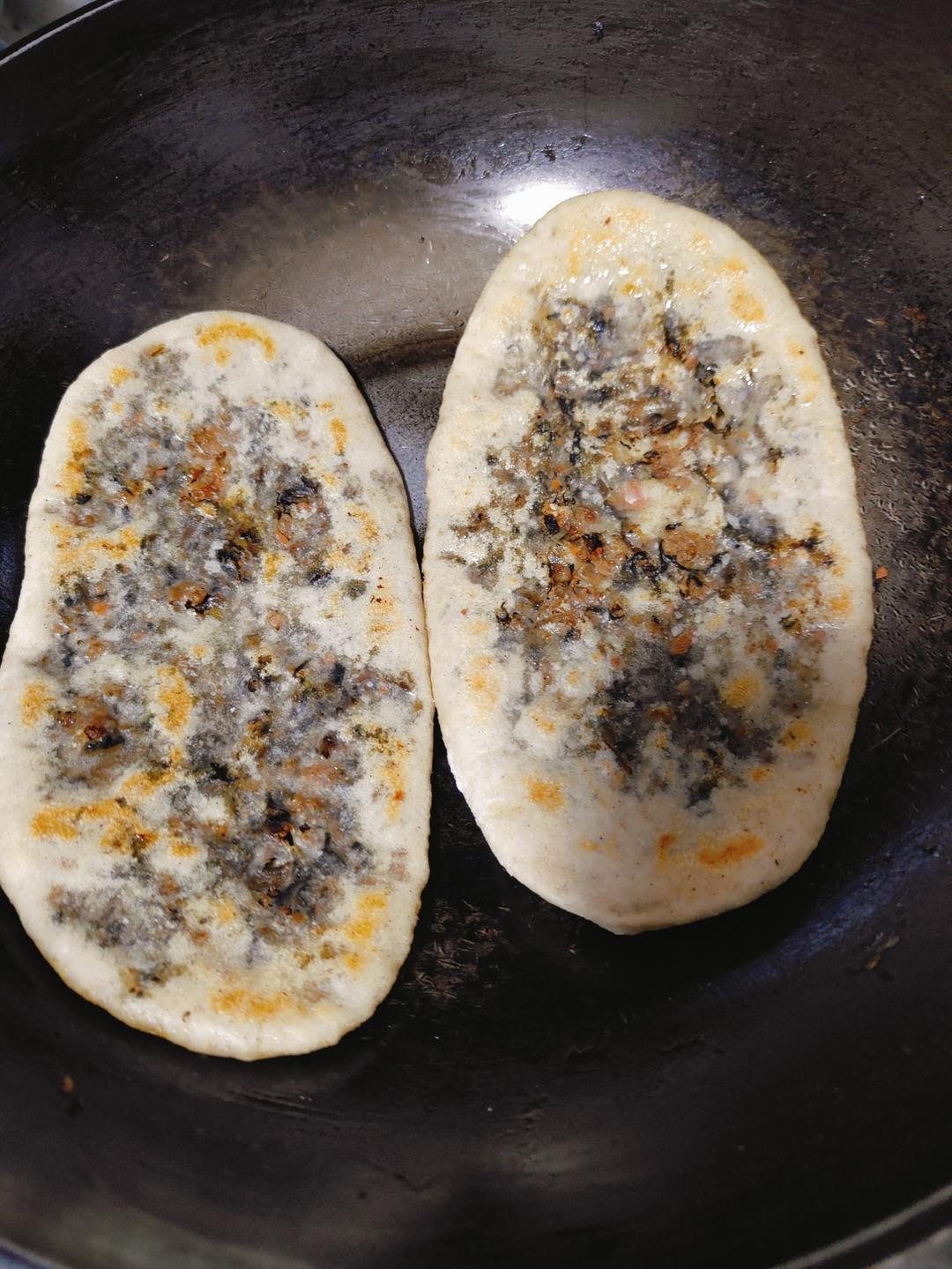Mei cai pancakes pan-frying until golden and blistered