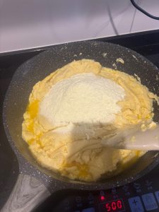 Mung bean paste being cooked down in a wide pan