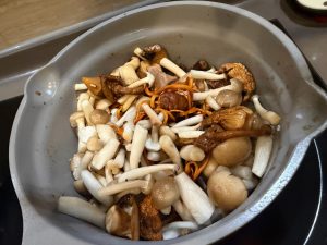 Add a little more oil to the wok and stir-fry the mushrooms until they release their moisture and start to brown.