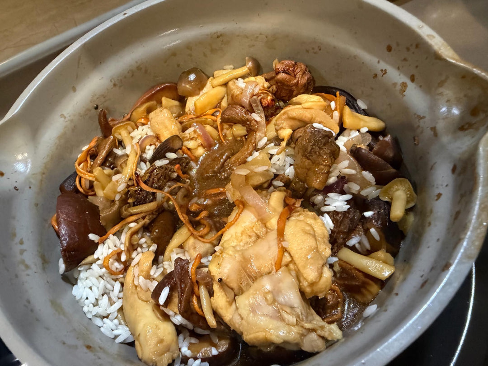 Add the dark soy sauce and toss everything together until the rice and meat are evenly coated.