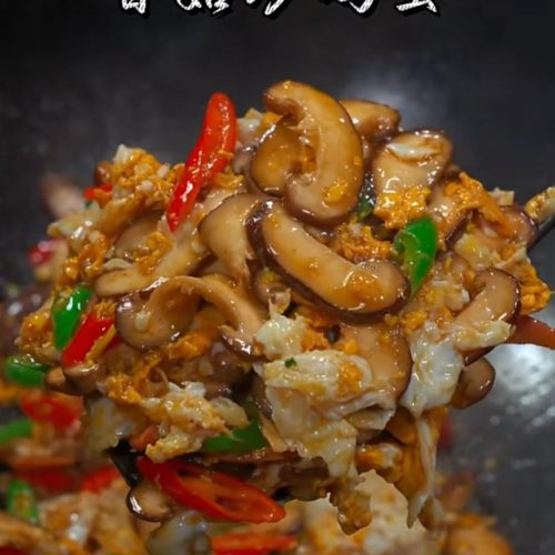 Mushroom and egg stir fry with peppers in a white bowl
