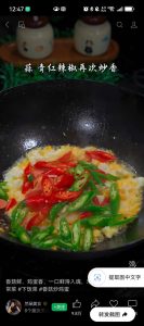 Adding garlic and peppers to the scrambled eggs