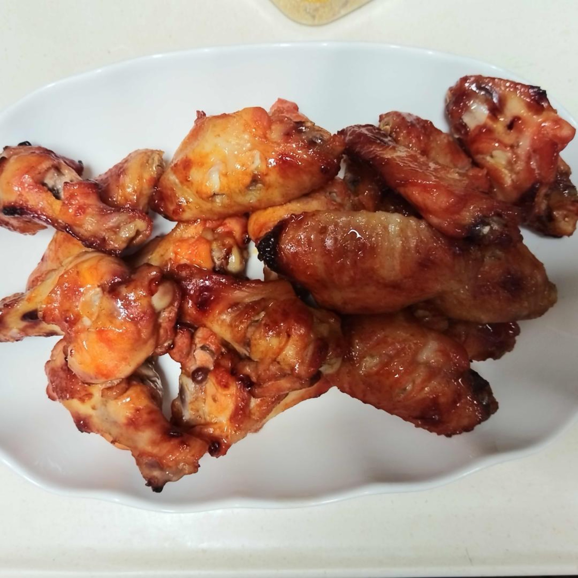 New Orleans roasted chicken wings on a wire rack, glossy with honey glaze