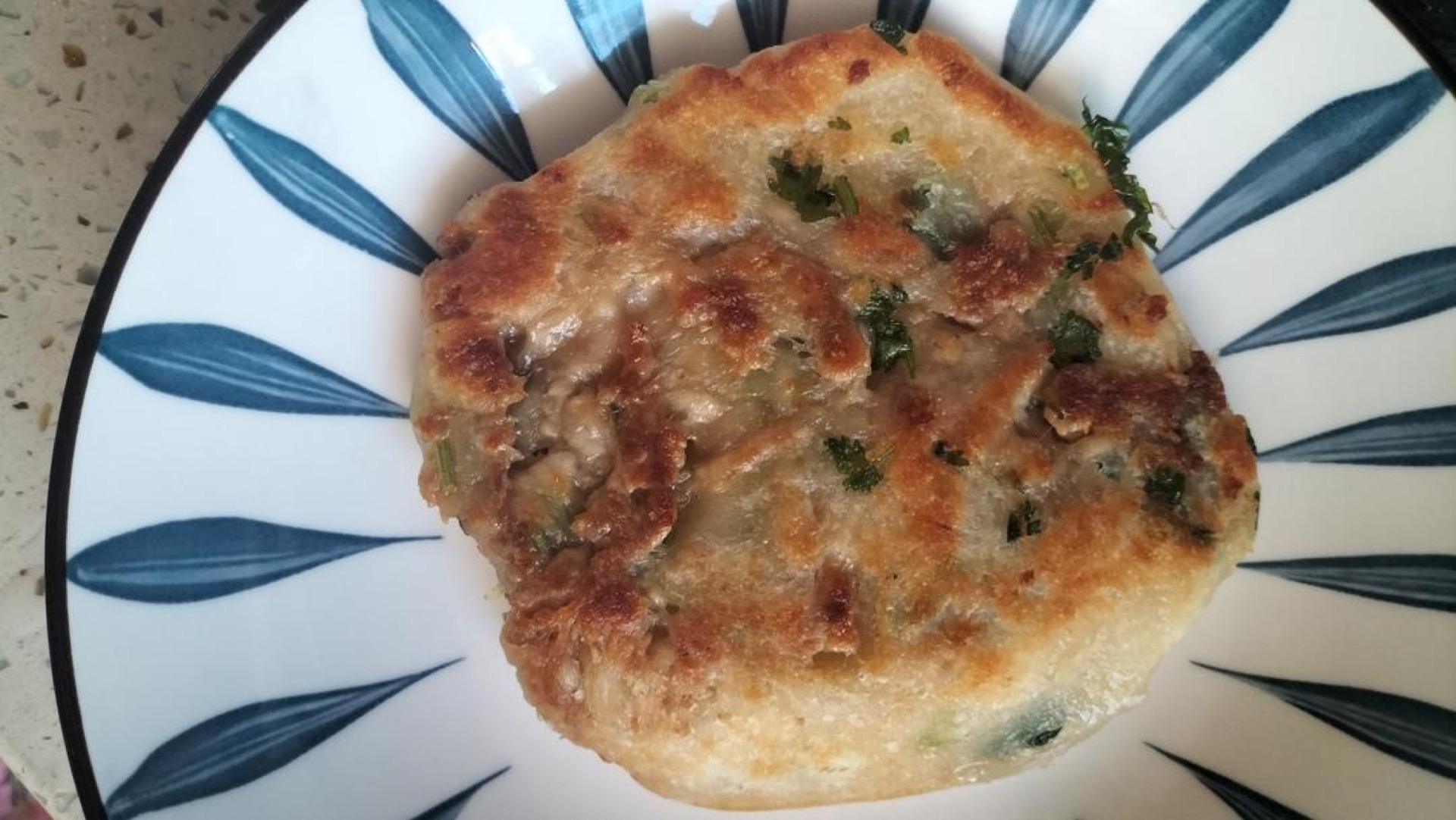 Golden pan-fried no-knead meat pies stacked on a plate with a crispy crust